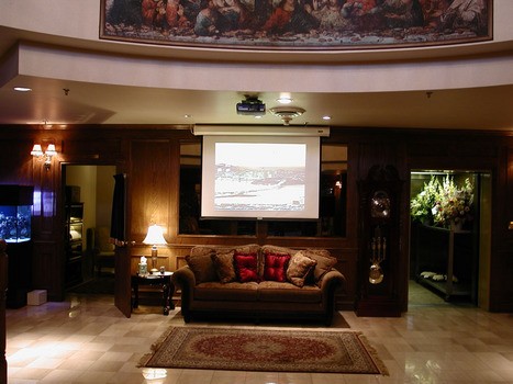 Funeral home with ceiling mounted projector and electric screen