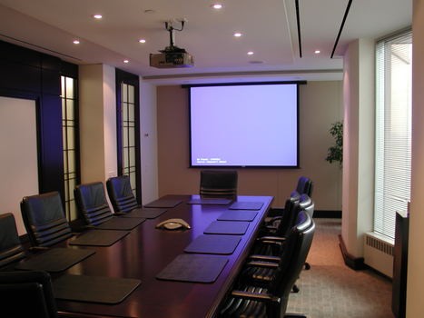 Executive Boardroom with recessed electric screen and ceiling mounted projector